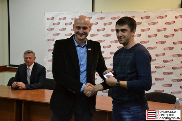 Назар Романюк отримує партійне посвідчення з рук депутата міськради Євгенія Ткачука